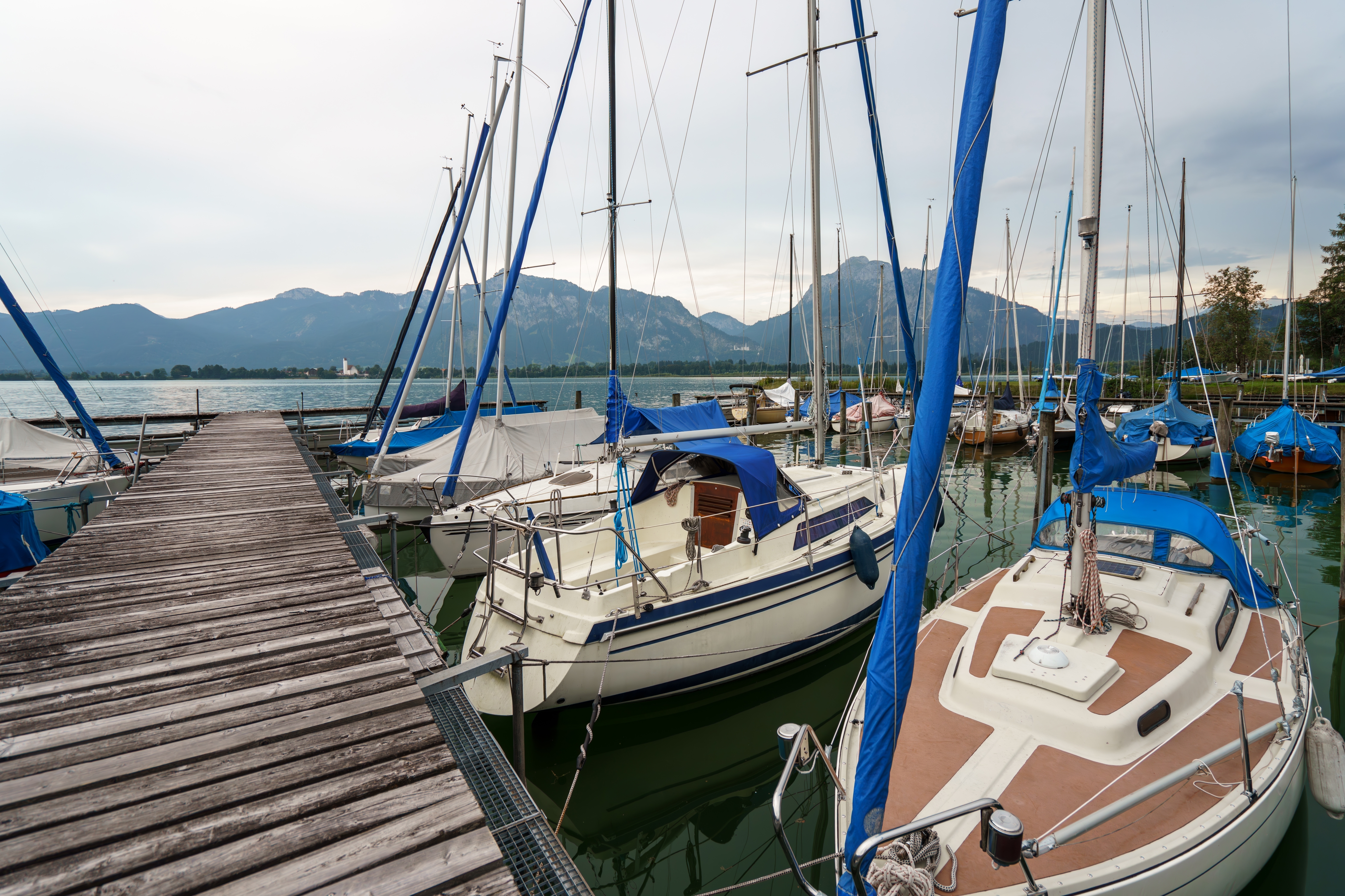 Sailboats docked on Lake Tegernsee with mountains, Bavaria